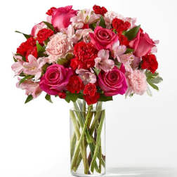 Pink and red mixed bouquet in a clear glass vase