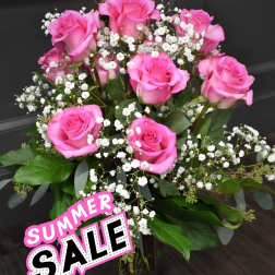 Pink roses with white baby's breath in a glass vase