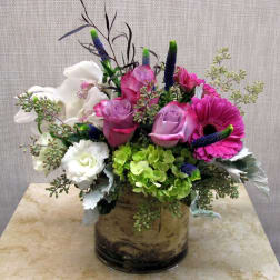 Pink and white flower arrangement in a glass vase