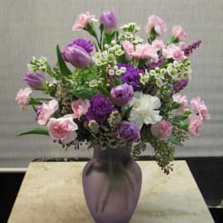 Pink and purple mixed bouquet in a purple vase