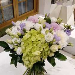 Bouquet of green hydrangea, white roses, and lavender flowers