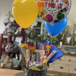 Birthday balloon bouquet with candy bars in a black container