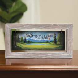 Framed memorial sign with a golf course scene and the words "Golfing on the Greens of Heaven"