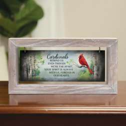 Framed cardinal memorial sign on a tabletop