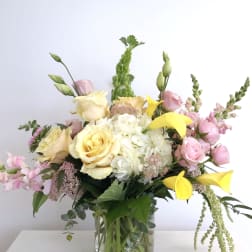 Bouquet of yellow and pink flowers in a glass vase
