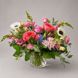 Mixed pink and white flower arrangement in a clear glass vase