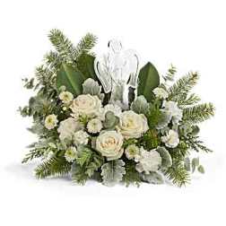 White roses and greenery arranged around a clear cross ornament