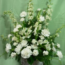 White floral arrangement in a wicker basket