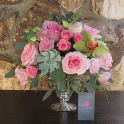 Pink rose bouquet in a silver vase with succulents and greenery