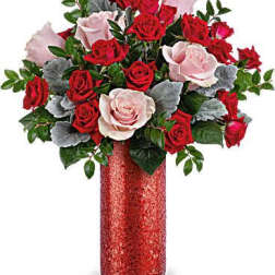 Red and pale pink roses in a red vase