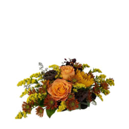 Orange roses and yellow flowers in a low autumn bouquet