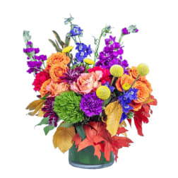 Colorful bouquet of mixed flowers in a green vase