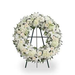 White floral wreath on a standing easel