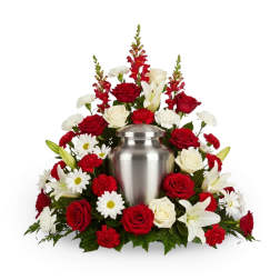 Red and white floral urn arrangement with roses, lilies, and daisies