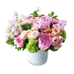 Pink and peach flower arrangement in a white vase