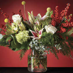 Mixed bouquet of white roses and lilies in a glass vase