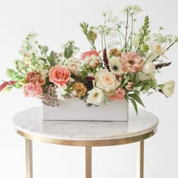 Mixed floral arrangement in a white rectangular box