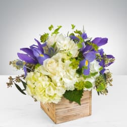 Purple and white mixed bouquet in a wooden box