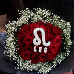 Red roses arranged with white baby's breath in black wrapping