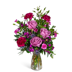 Pink and magenta mixed bouquet in a clear glass vase