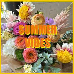 Colorful bouquet with roses, ranunculus, and yellow daisy-like blooms