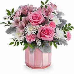 Pink roses and mixed flowers in a pink glass vase