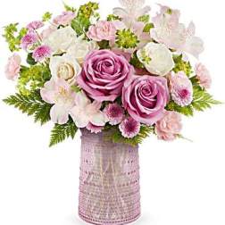 Pink and white flower arrangement in a textured vase