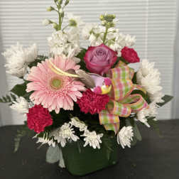 Pink gerbera and rose bouquet in a green vase with a plaid ribbon