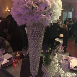 Tall white and lavender floral centerpiece in a crystal vase