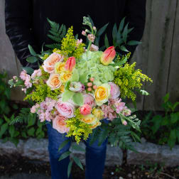 Handheld bouquet of pastel roses, tulips, and green hydrangea