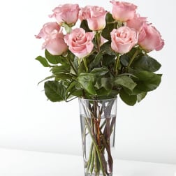 Pink roses arranged in a clear glass vase