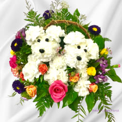 White teddy bear floral arrangement with colorful roses and daisies