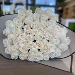 Large bouquet of white roses wrapped in gray paper