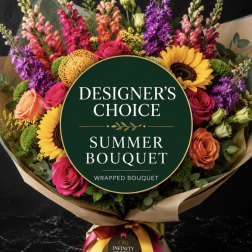 Wrapped bouquet with sunflowers, roses, and colorful snapdragons