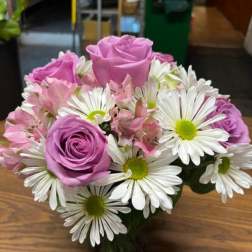 Pink roses and white daisies in a compact bouquet