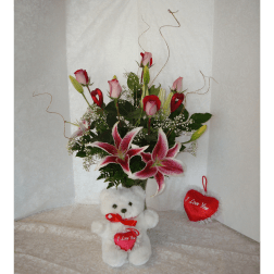 Bouquet of pink roses and lilies with a teddy bear and heart ornaments