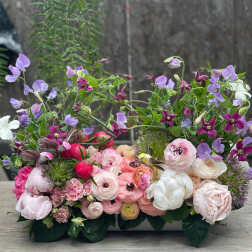 Low floral arrangement with pink, white, and purple blooms