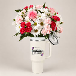Bouquet of pink roses, carnations, and white daisies in a handled tumbler cup