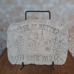Decorative stone plaque with a tractor and the words "Life is Better on the Farm"