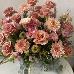 Peach and pink roses with chrysanthemums in a glass vase