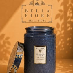 Blue scented candle in a decorative glass jar with lid