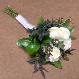 White rose bouquet with dark greenery and a white ribbon wrap