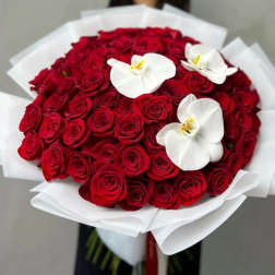Bouquet of red roses with white orchid blooms wrapped in white paper