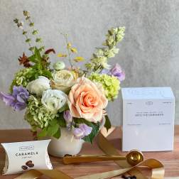 Mixed bouquet in a white vase with coffee and caramel gift items