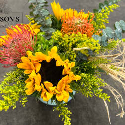 Bright mixed bouquet with a sunflower and pink, orange, and yellow blooms