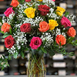 Mixed roses in a glass vase with baby's breath