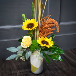 Sunflower and rose arrangement in a tall white vase
