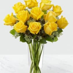 Bouquet of yellow roses in a clear glass vase