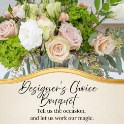 Mixed bouquet of pale roses and white blooms in a glass vase