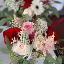 Bouquet of red, pink, and white roses with airy filler flowers
